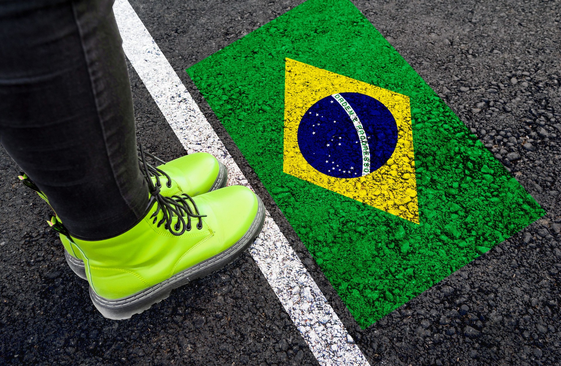 a womman standing next to flag of Brazil